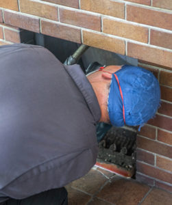 Man inspecting a chimney