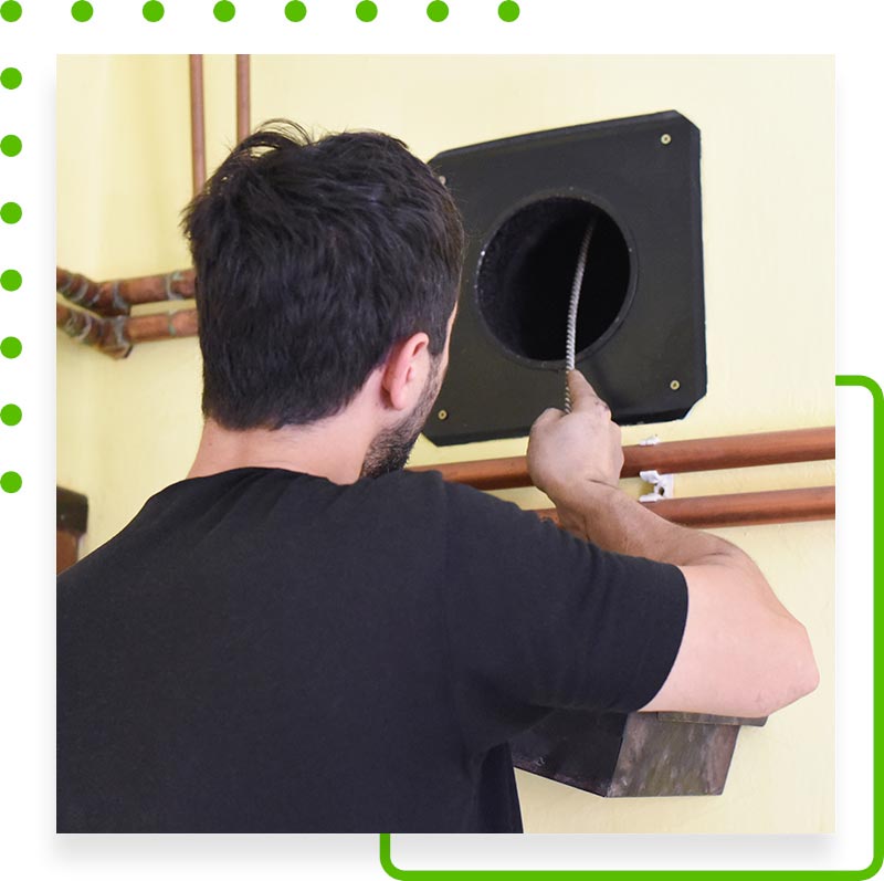 Man cleaning air duct